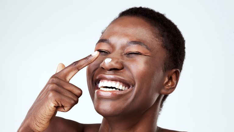 laughing woman with moisturiser on nose 