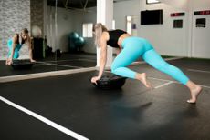 Woman exercising using Bosu ball