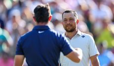 Xander Schauffele and Rory McIlroy shake hands on the 18th