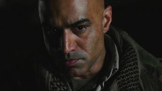 Faran Tahir as Raza looking at screen in Iron Man movie