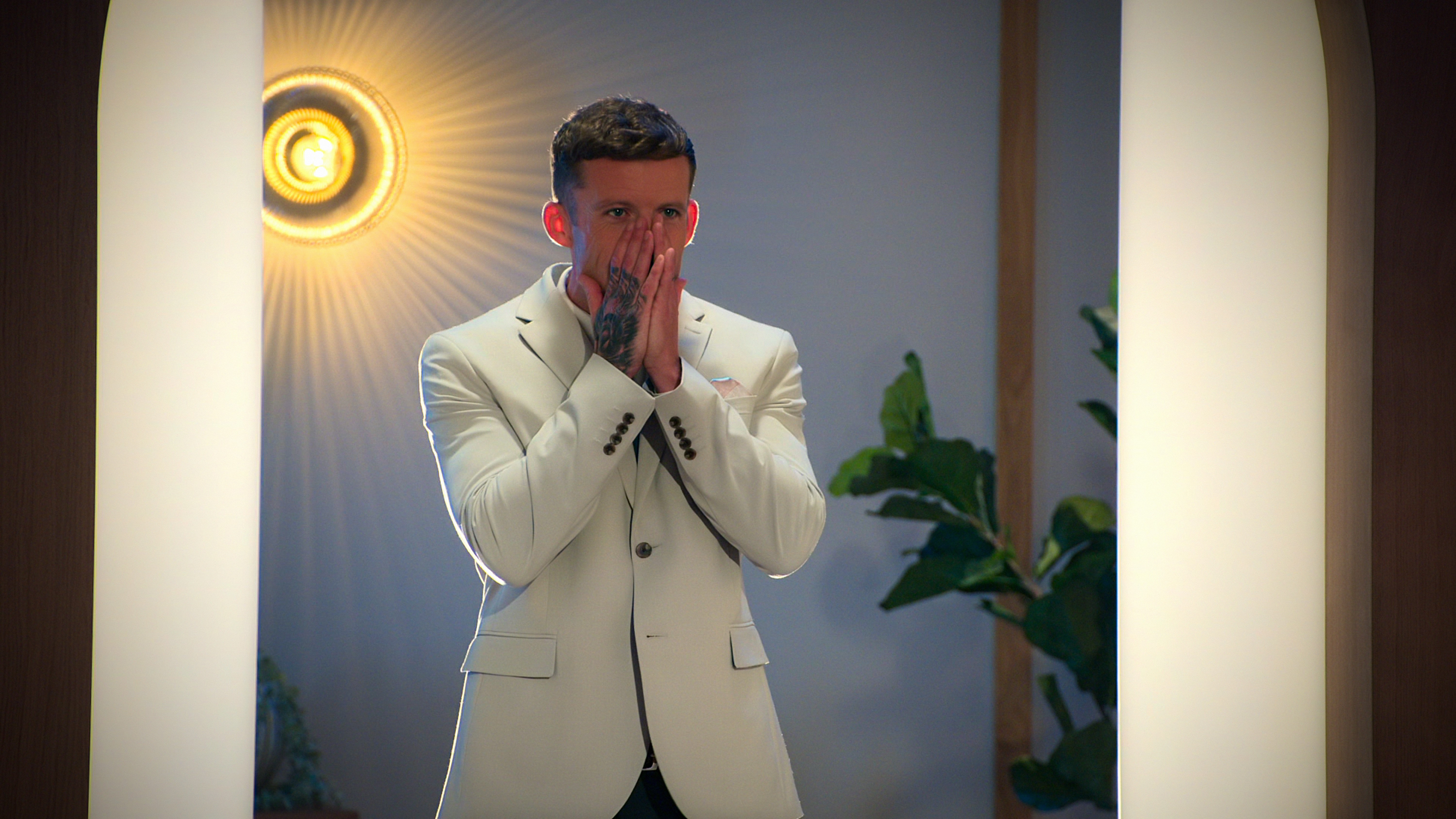 billy covers his face in a state of shock in a still from love is blind uk season 2