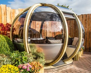 glazed timber circular garden pod on a brick paved patio