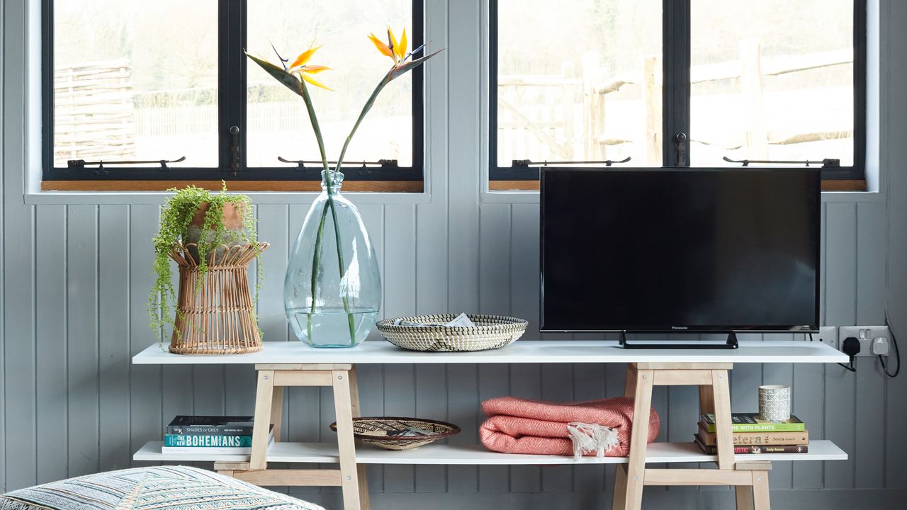 TV on TV stand in blue living room