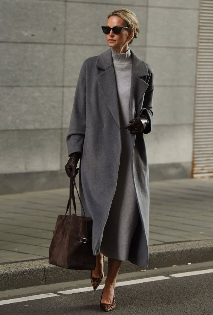 @anoukyve wears a grey long coat, knitted dress, brown heels and a suede tote
