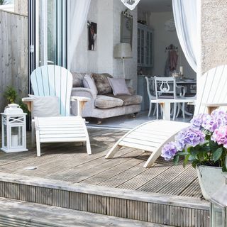 open living room with chairs and white wall