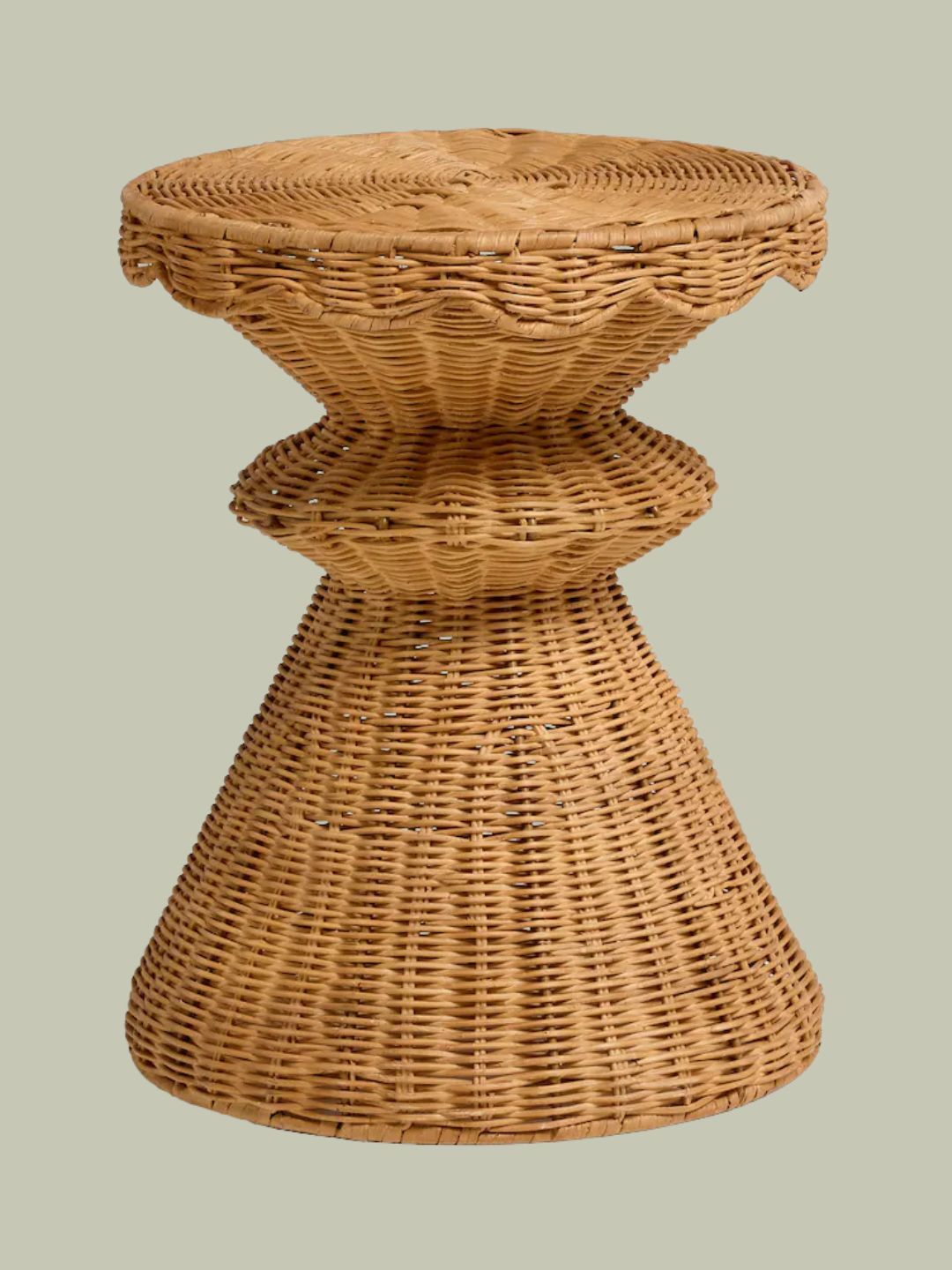 Natural Rattan Scallop Side Table against pale green background.
