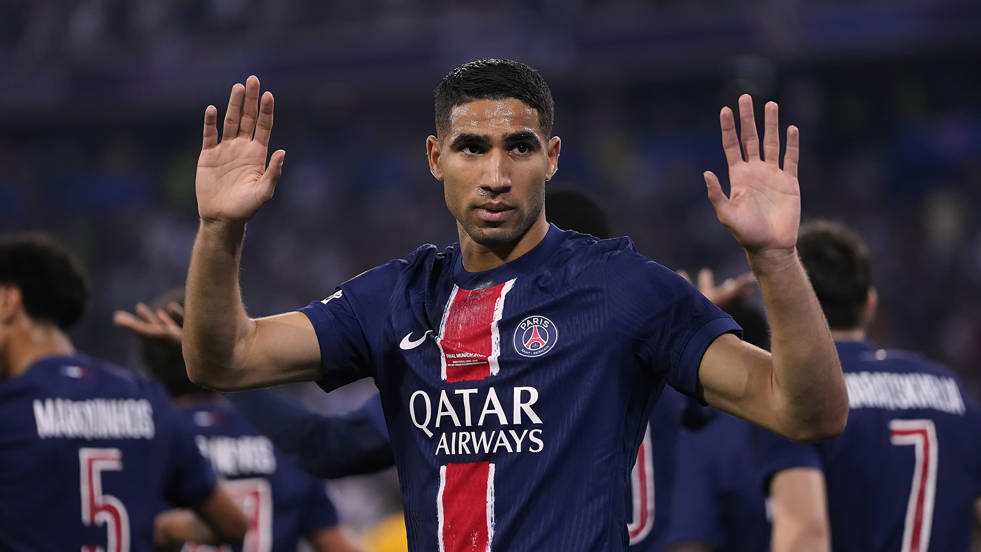 PSG footballer Achraf Hakimi holds his hands up during the 2025 Champions League final