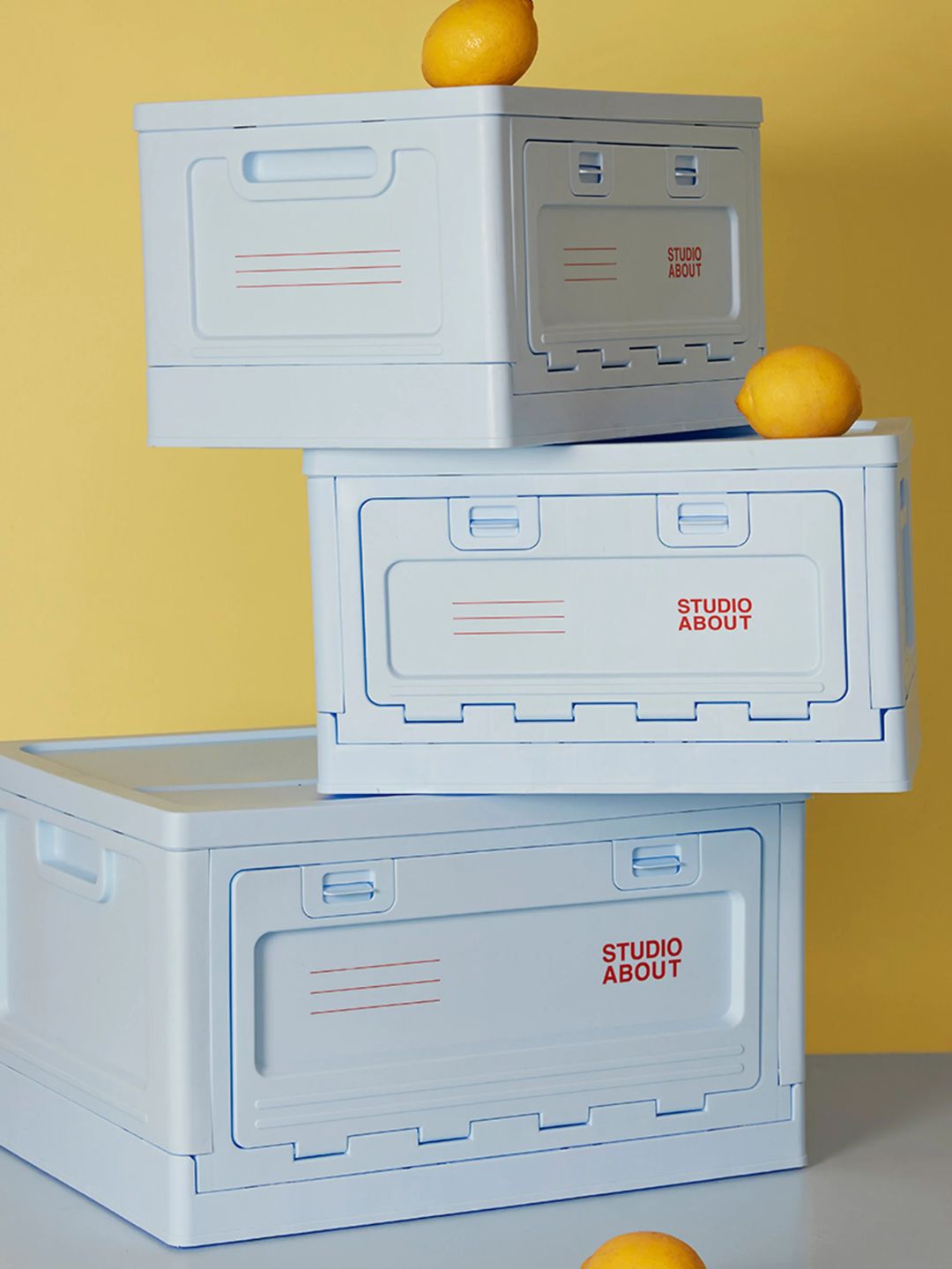 A blue storage box with red lettering from Studio About