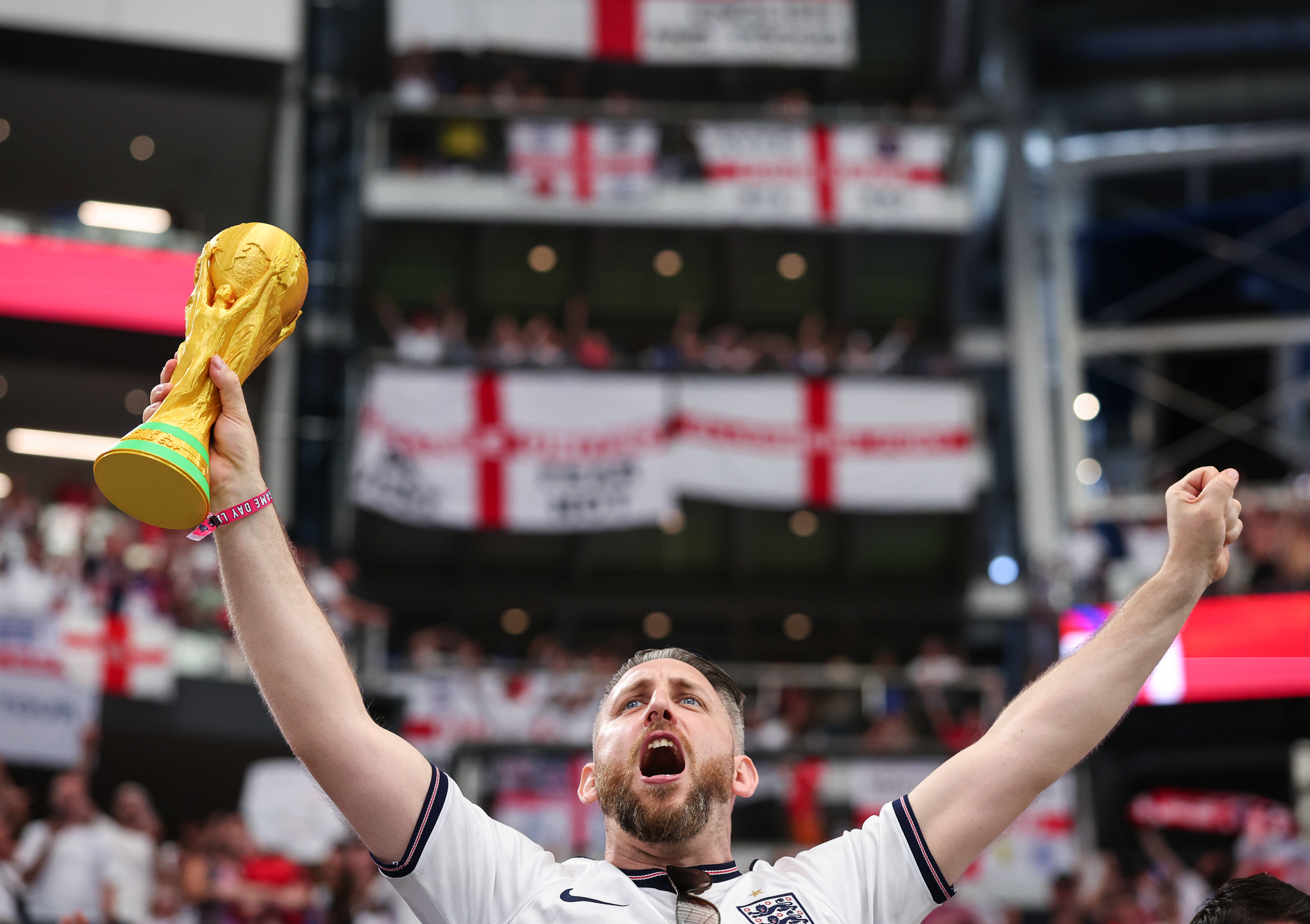 DALLAS, TEXAS - JUNE 17: An England fan celebrates with a replica FIFA World Cup trophy during the FIFA World Cup 2026 Group L match between England and Croatia at Dallas Stadium on June 17, 2026 in Dallas, United States. (Photo by Marc Atkins/Getty Images)
