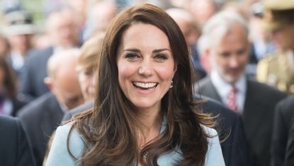 Kate Middleton smiling in blue suit