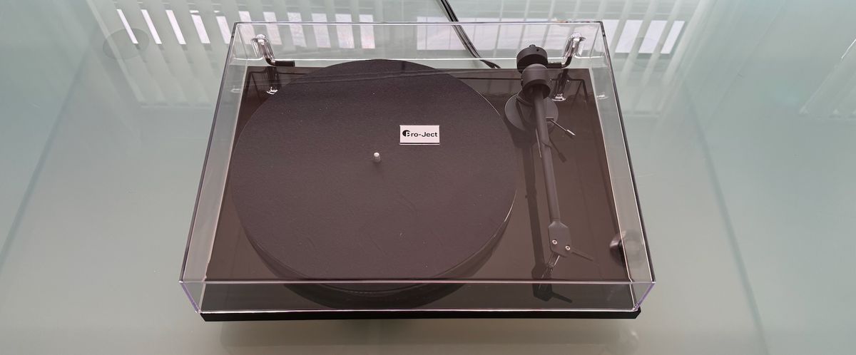 Pro-Ject E1 turntable on a glass surface