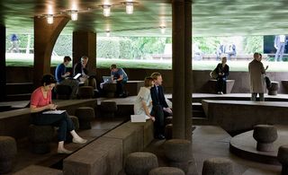 Interior of structure in garden of Serpentine Gallery with cork covered seats, steps and floors