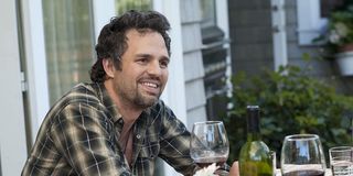 Paul (Mark Ruffalo) smiles while sitting at an outdoor table in 'The Kids Are All Right'