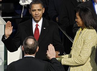 First Lady Michelle Obama watches Barack take the Oath of Office.