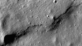 A type of curved hill known as a lobate scarps near the Mare Frigoris region of the Moon was captured here by the LRO.