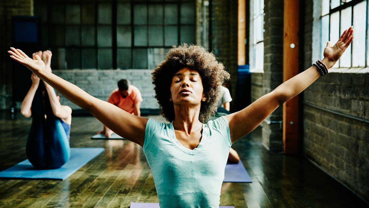 A young woman does yoga.