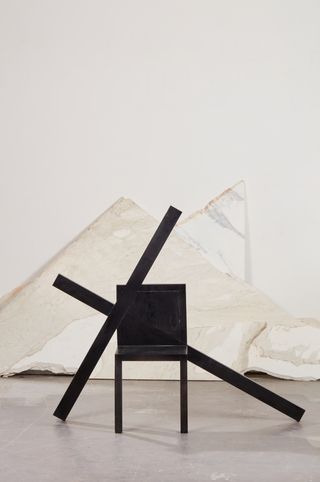 Black chair with x shaped motif by Paolo Palucco