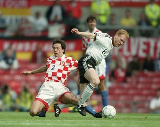 Croatia's Nikola Jurcevic attempts to dispossess Germany's Matthias Sammer at Euro 96.