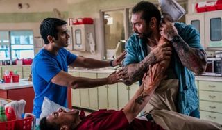 Stuber Kumail Nanjiani tries to calm Dave Bautista down, as he holds a bloody leg