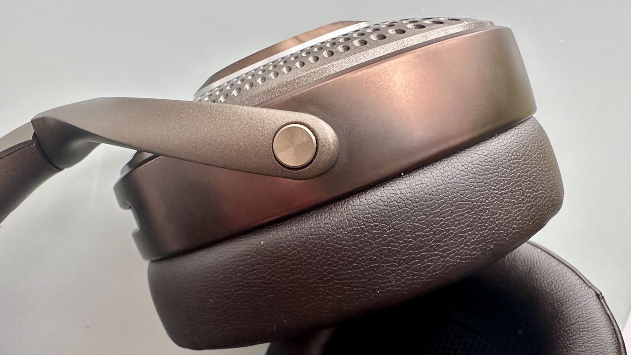 Focal Bathys Mg in bronze, featuring ear cup detail on gray background