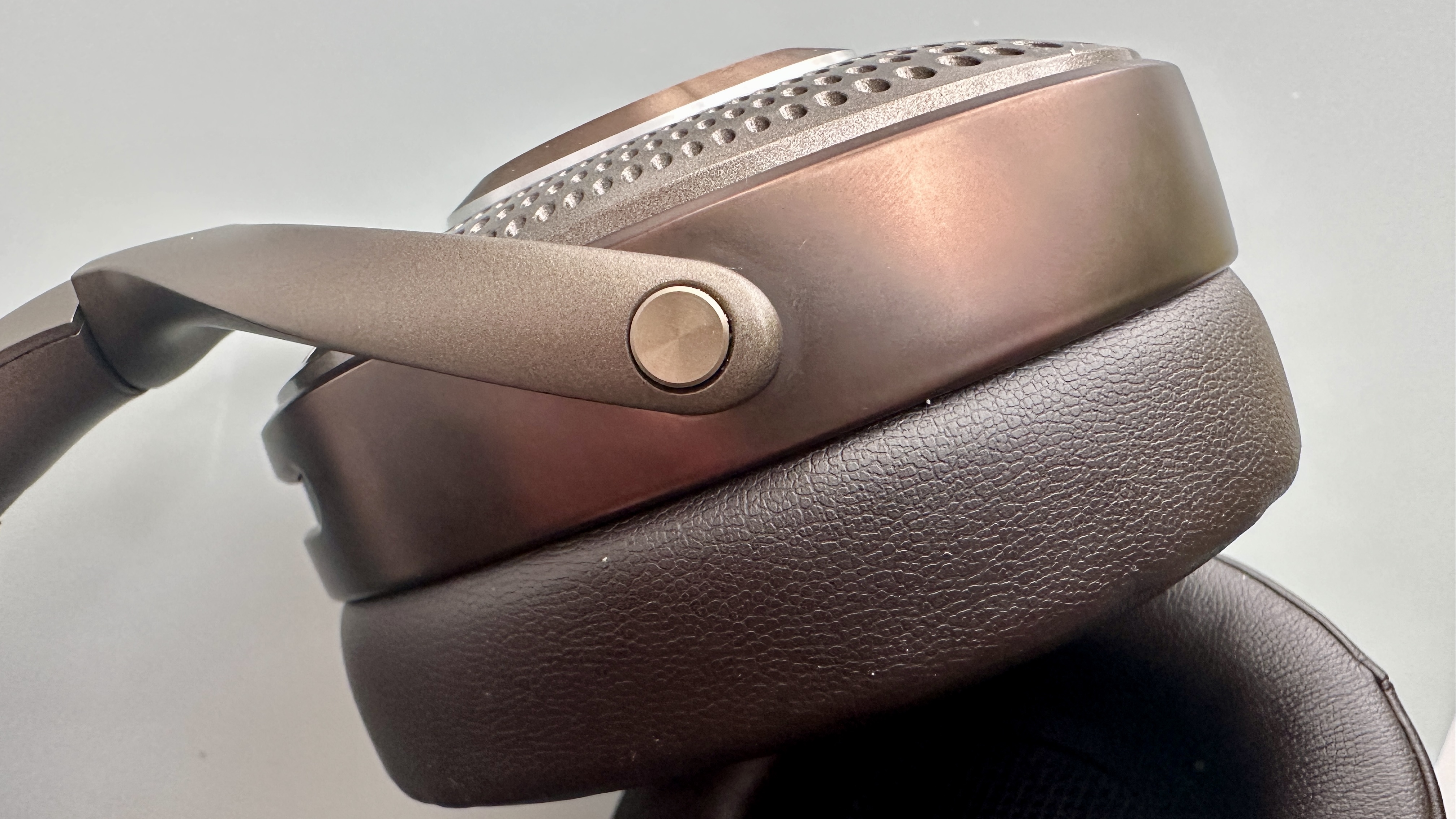 Focal Bathys Mg in bronze, featuring ear cup detail on gray background