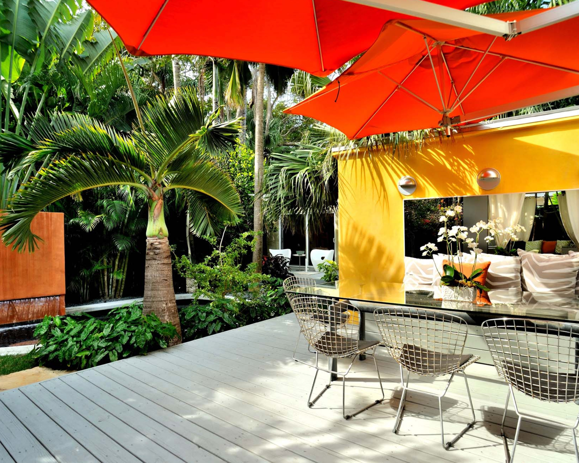 A residential backyard with outdoor room, deck, and deck shade