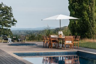 Pool with decked area with sitting area and hot tub