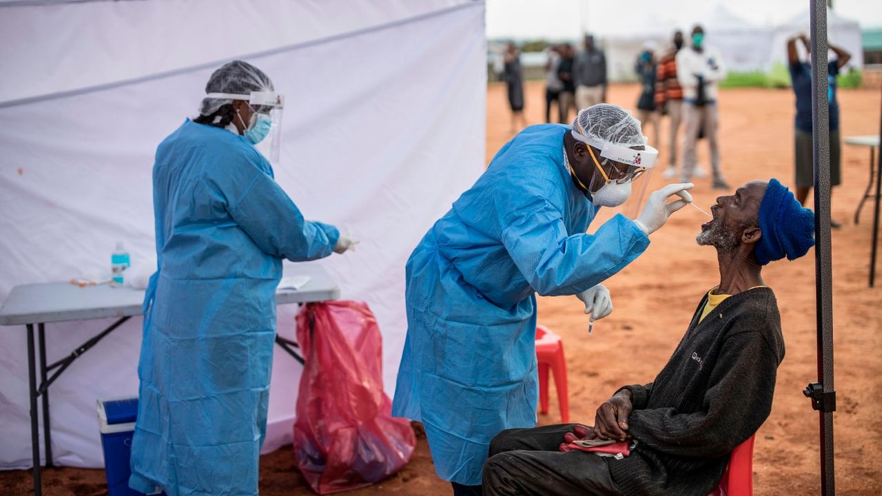 A man in Johannesburg receives a testing swab for Covid 