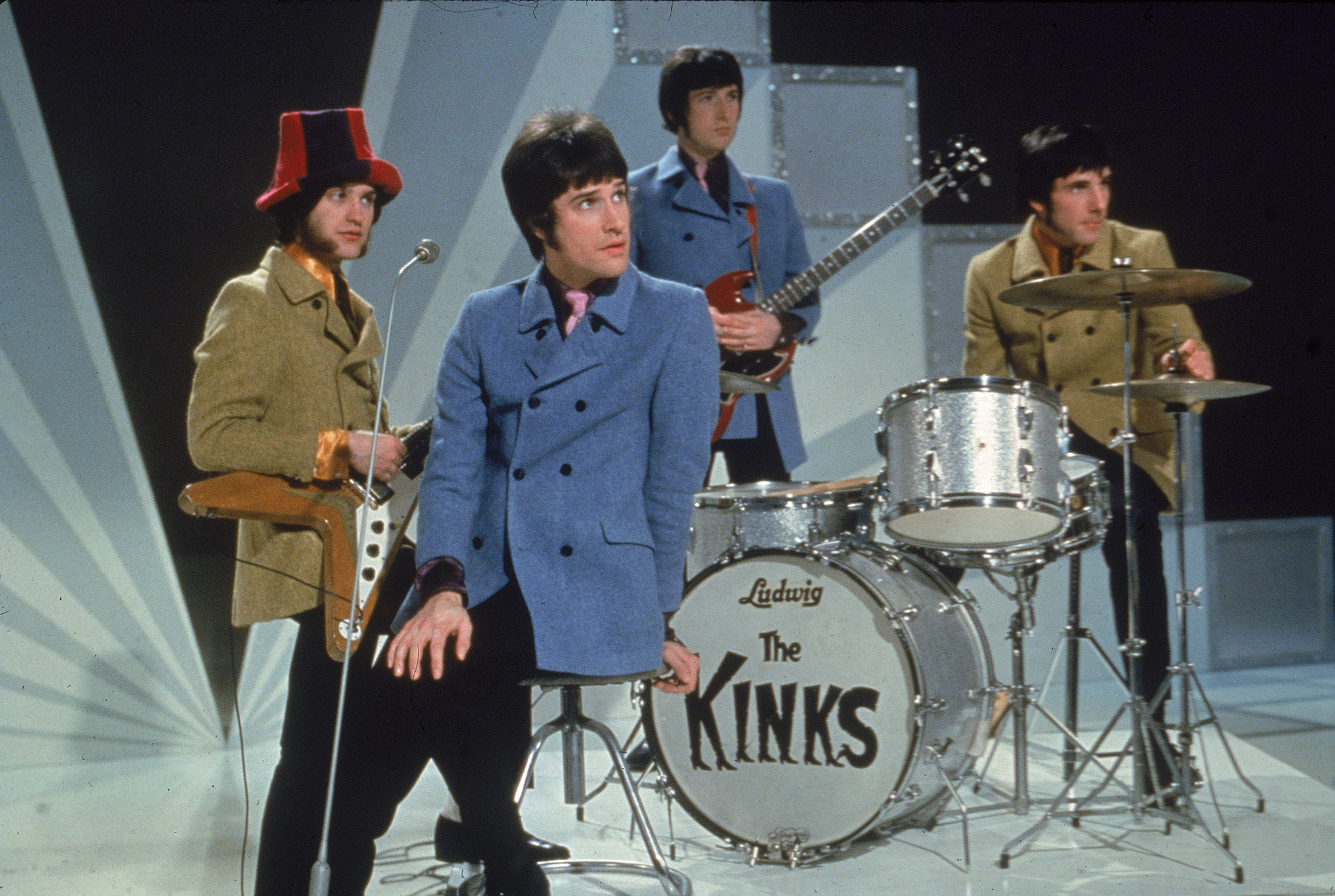 The Kinks pose on a TV set in 1968: (L-R) Dave Davies, Ray Davies, Peter Quaife, and Mick Avory