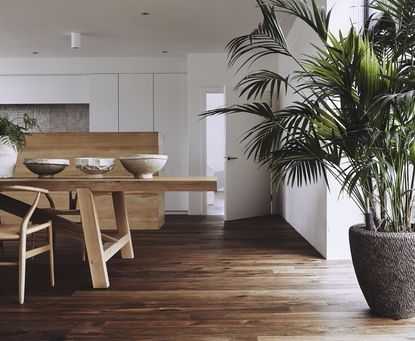 A large dining room with wooden furniture and dark wood panelled flooring