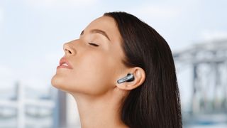 Woman wearing Earfun Air 2 earbuds.