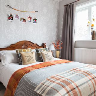 bedroom with wallpaper and grey curtains