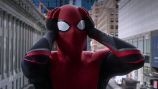 Spider-Man holds his head in shock as he stands above the city in Spider-Man: Far From Home.