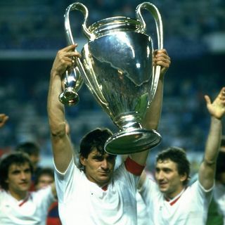 Steaua Bucharest captain Stefan Iovan holds the European Cup amid the celebrations after the Romanian side's win on penalties over Barcelona in the 1986 final.