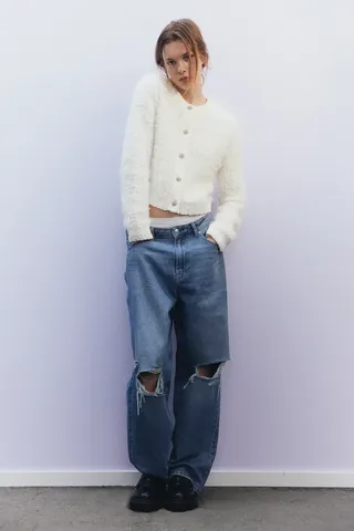 model wears Fluffy Bouclé-knit Cardigan and baggy jeans