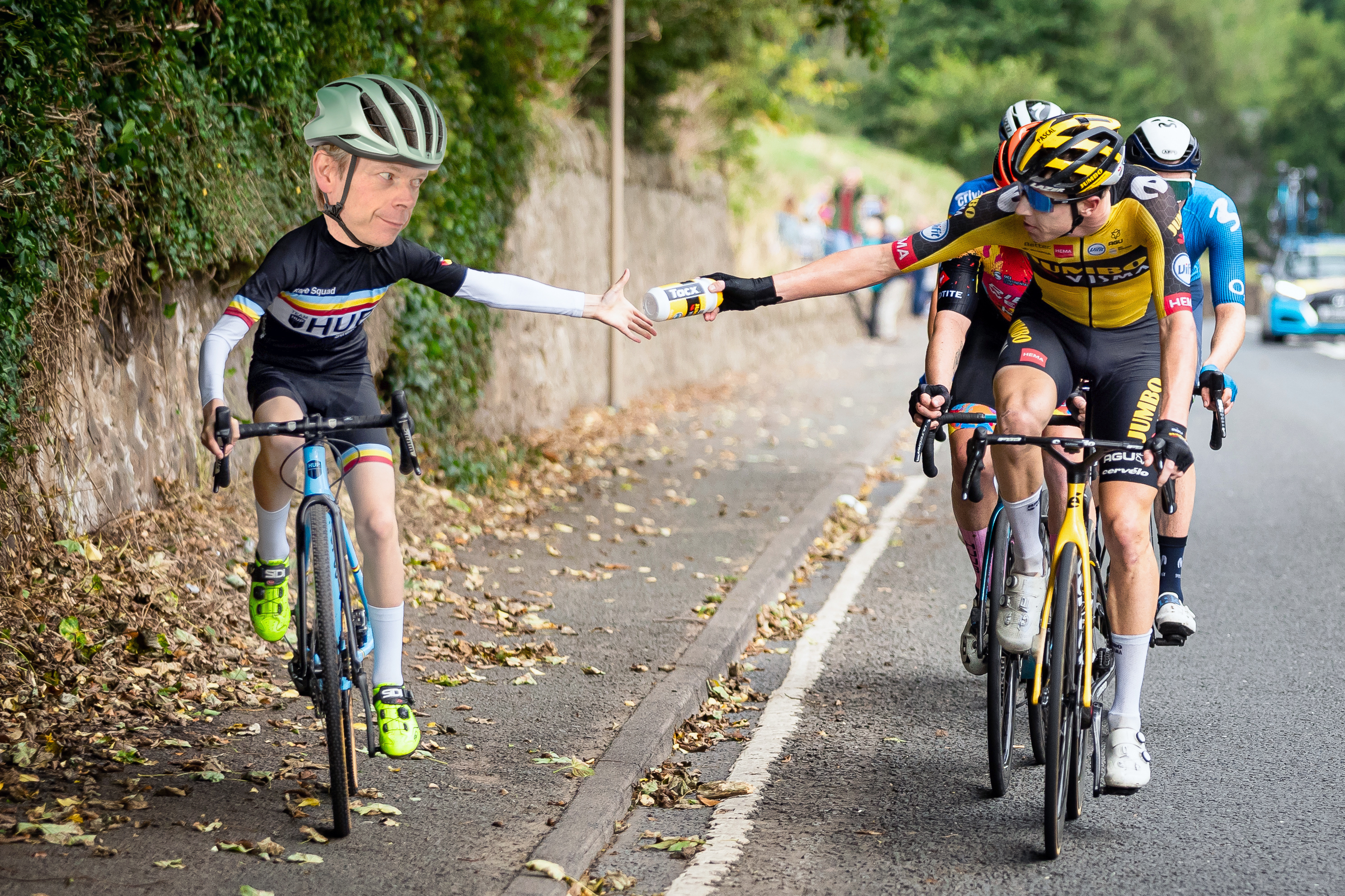 Hutch rides alongside the peloton taking a bottle