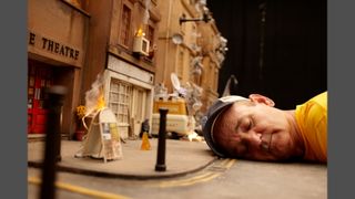 Bill Murray lying on the set of Fantastic Mr Fox. He is lying down and the set is small, so Murray looks like a giant.