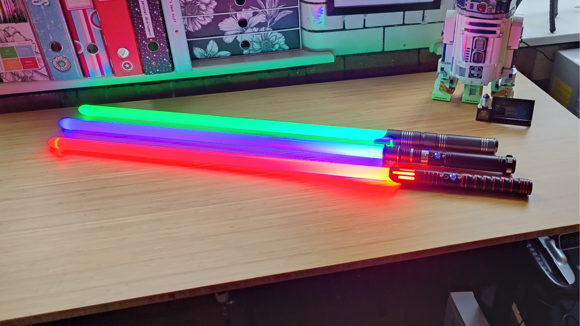 Encalife lightsabers switched on showing red, blue, and green blades.