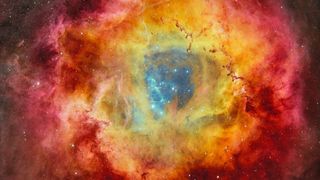 A circular nebula with rings of rainbow colors, with blue on the inside, yellow in the middle, and red on the outside