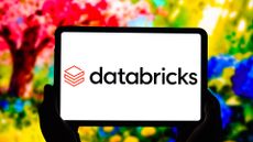 Databricks logo and branding pictured on a tablet screen against vibrant multi-colored background.