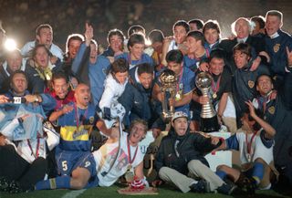 Boca Juniors players celebrate with the Intercontinental Cup after victory over Real Madrid in Tokyo in November 2000.