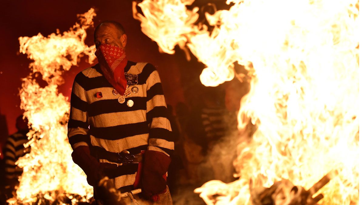 Alongside the year's topical effigy, attendees also torch a traditional one of Guy Fawkes