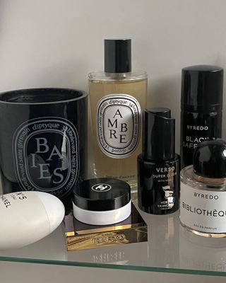 Diptyque and Byredo perfumes on a shelf