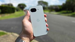 Google Pixel 10a in hand on street corner