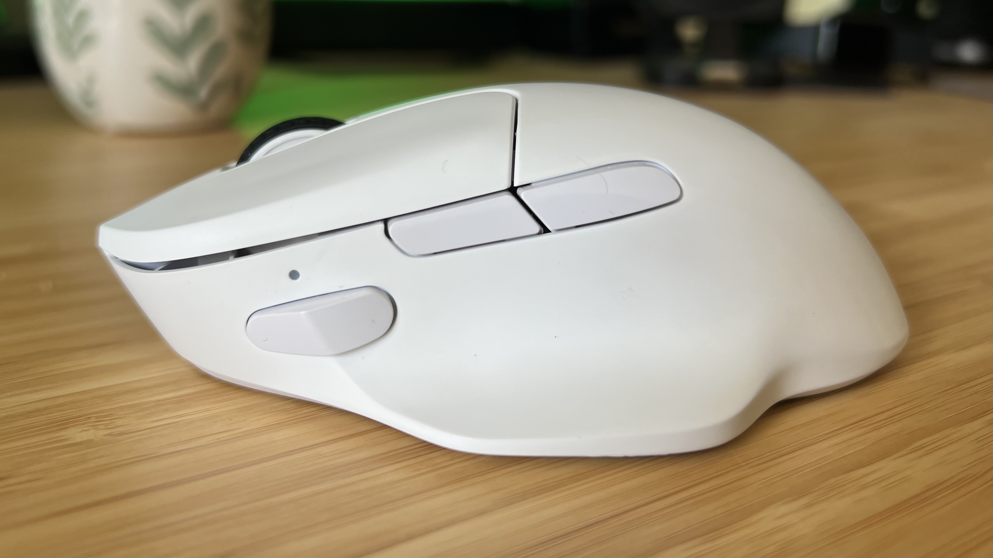 Side view of Keychron M7 8K gaming mouse showing two side buttons and a third button towards the front of the device