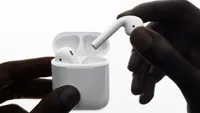 Best Apple headphones: AirPods being placed inside wireless charging case