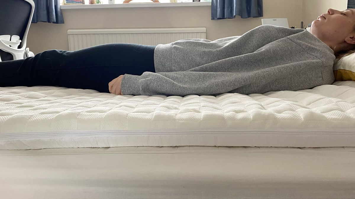 Levitex mattress topper with reviewer lying on her back