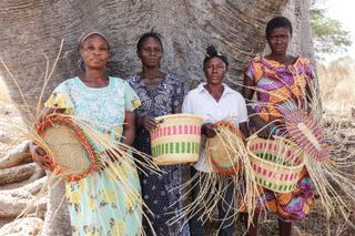 Women with the baskets they've weaved