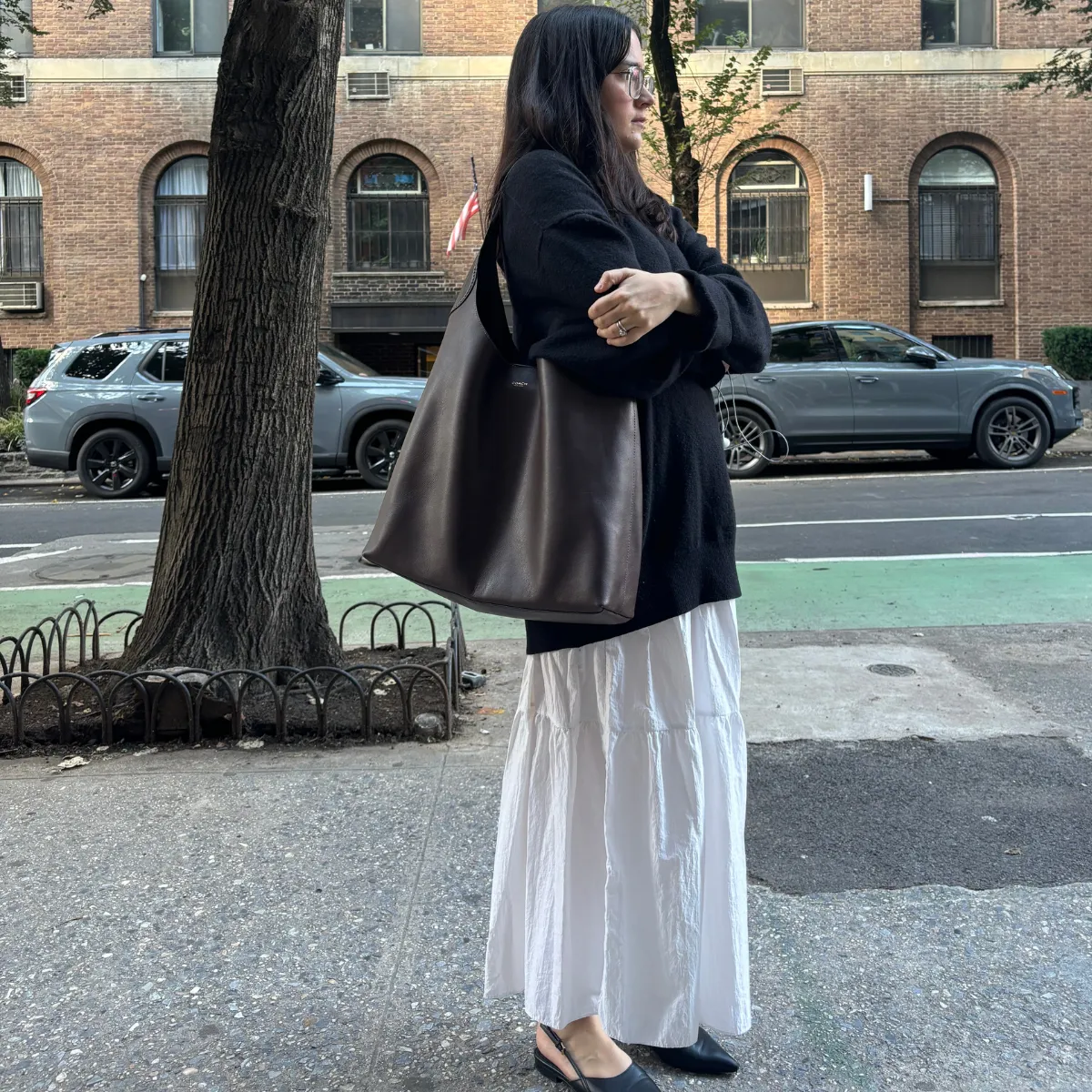 Julia Marzovilla carrying a brown leather Coach Brooklyn bag