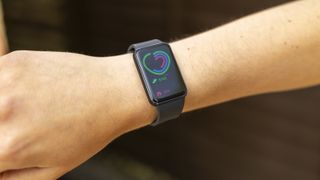 The Samsung Galaxy Fit 3 watch in grey worn on a female wrist